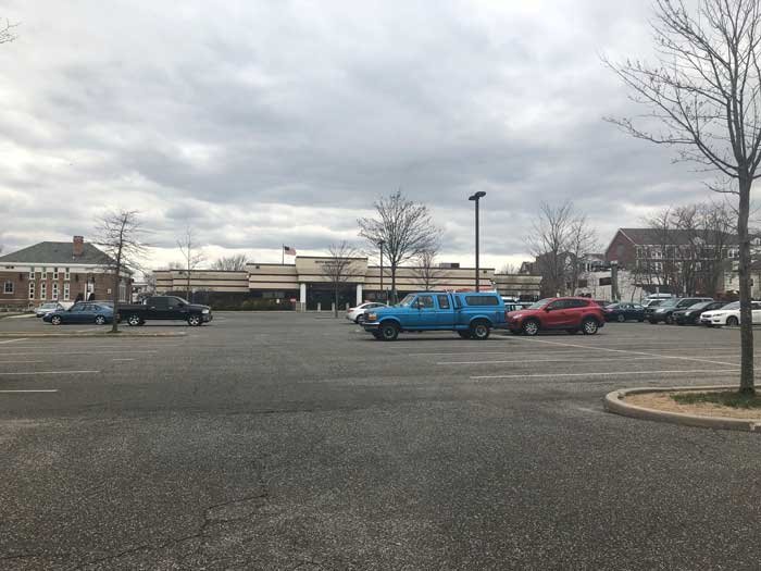 Original plans for deck parking in the Suffolk County 6th District Court lot on West Main Street in Patchogue was officially ditched, with plans to rework and expand the existing parking lot to accommodate for additional spaces at a smaller price tag.